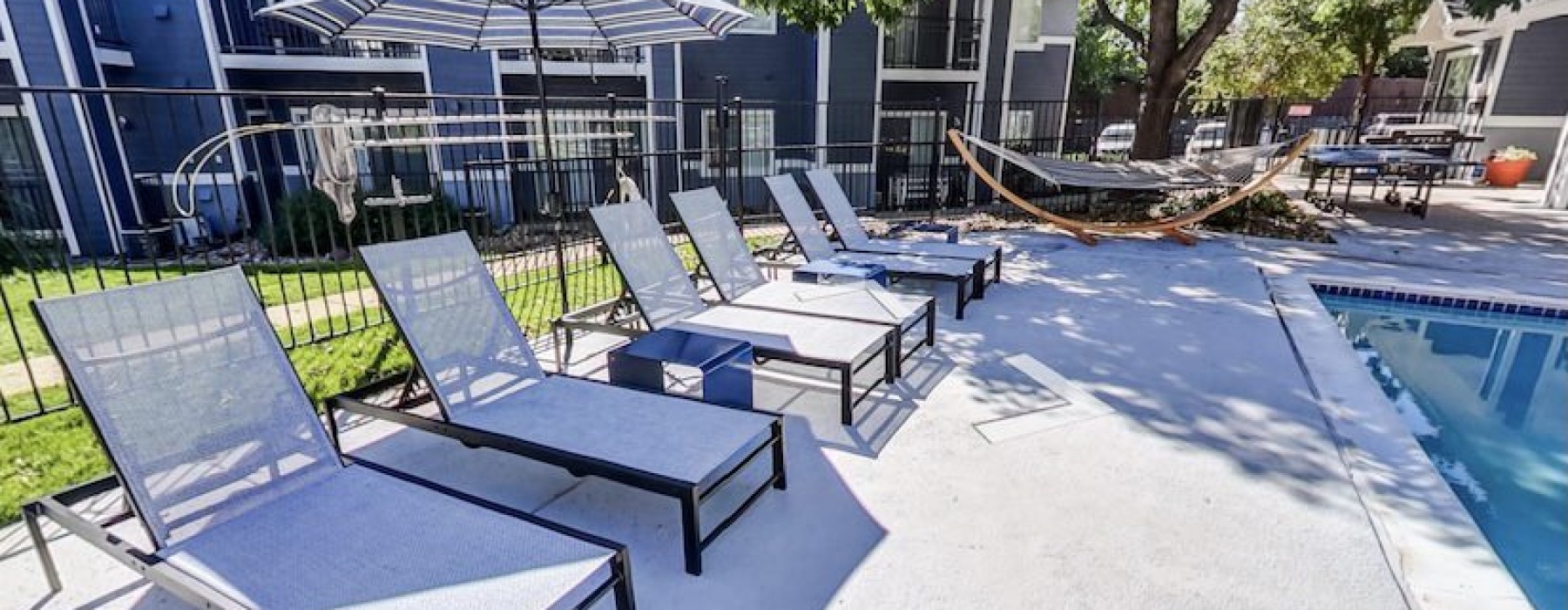 a pool with lounge chairs
